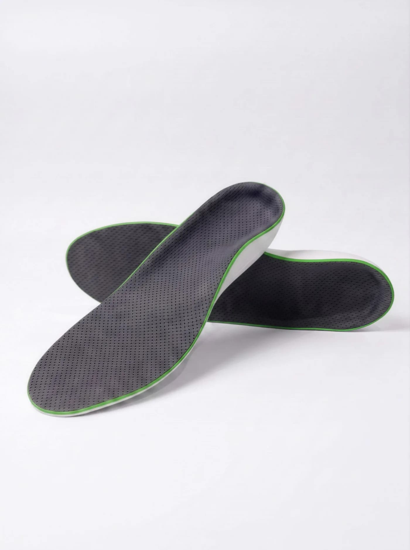 A pair of Akrolimb Comfort insoles — grey mesh tops with a green trim edge