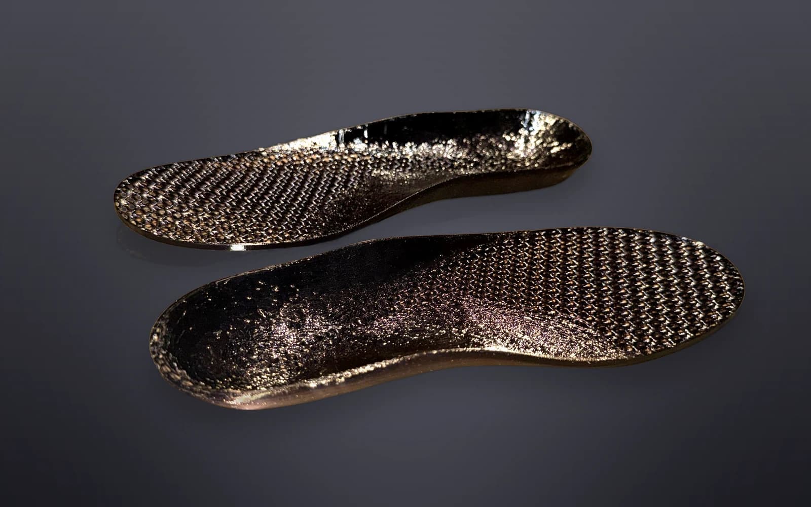 The Akrolimb PEBA Sport insole — a glossy 3D-printed lattice pair built for impact