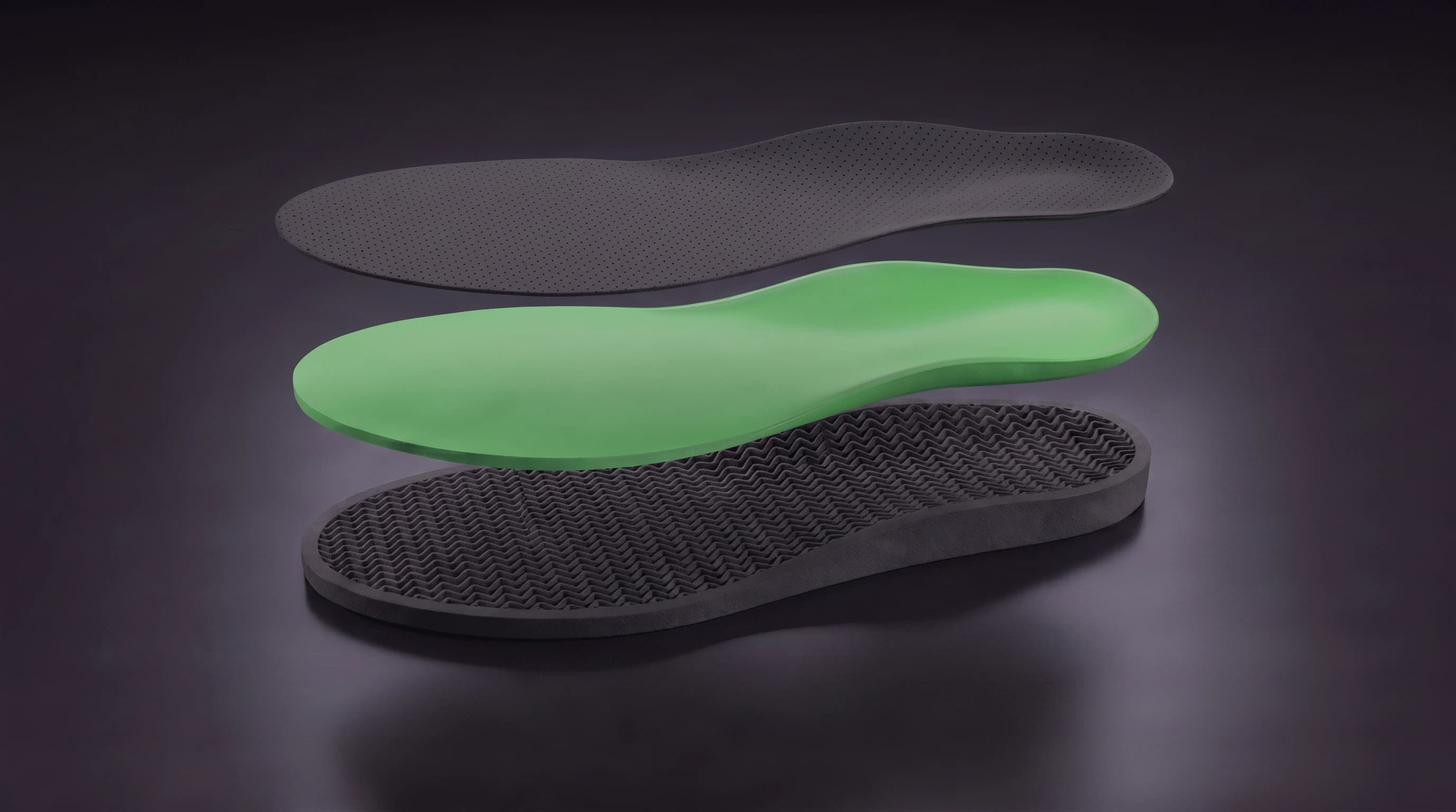 An Akrolimb insole shown as three separated layers — a skin-safe liner, a cushioning core, and a 3D-printed lattice base